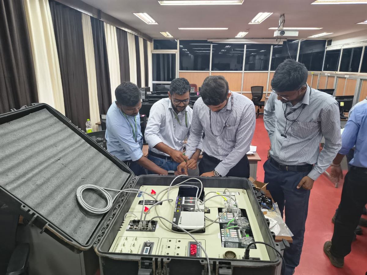 Engineers working with a portable PLC training kit
