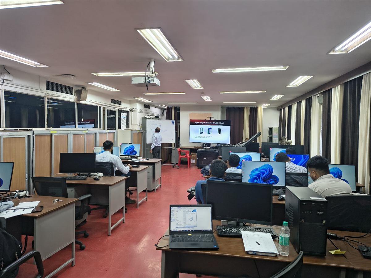 Corporate PLC training batch working at programming stations