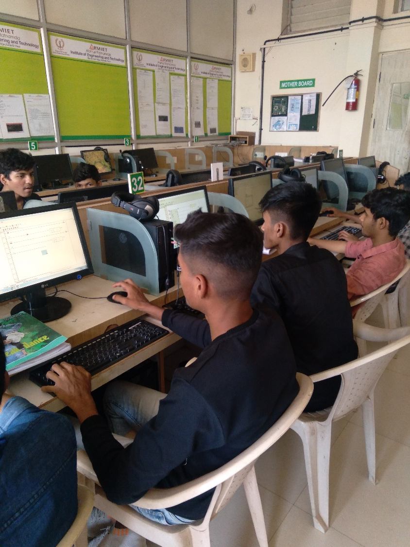 Students working on PLC programming exercises in a computer lab