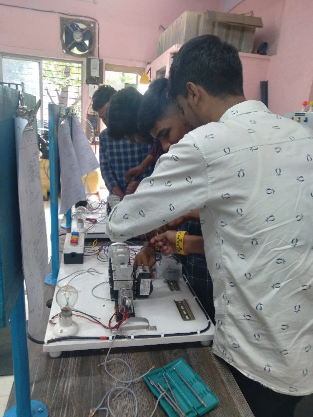 Trainees wiring a control practice board during a hands-on session